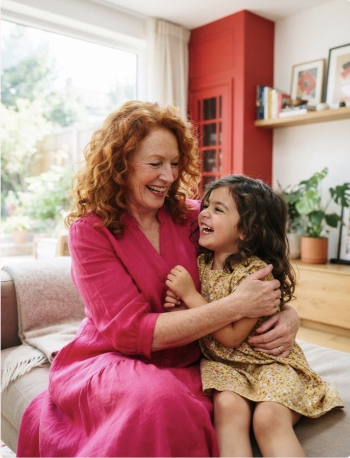 A woman on a sofa with a child against her