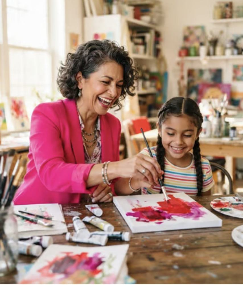 Paints and small hands across a table
